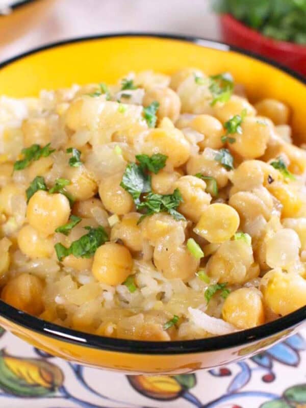 a single serving of chickpea curry in a bowl over rice.