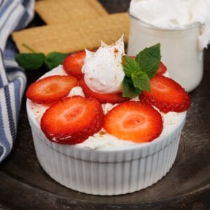 a mini icebox cake topped with strawberries on a tray