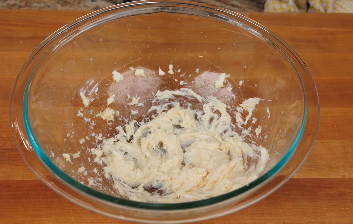 cream cheese and sugar in a mixing bowl whipped together with an electric mixer