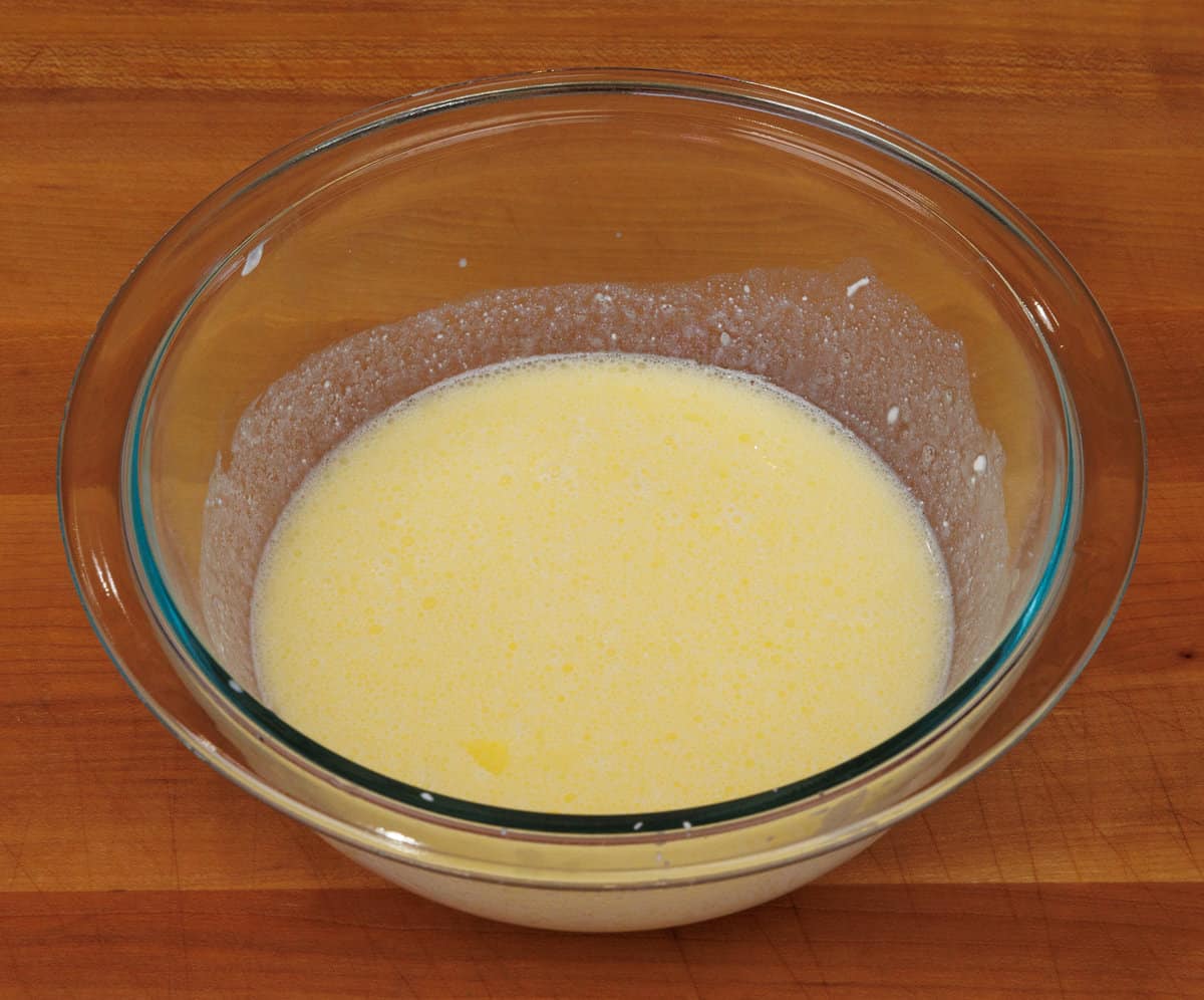 egg yolk, sour cream, milk, and melted butter whisked together in a mixing bowl