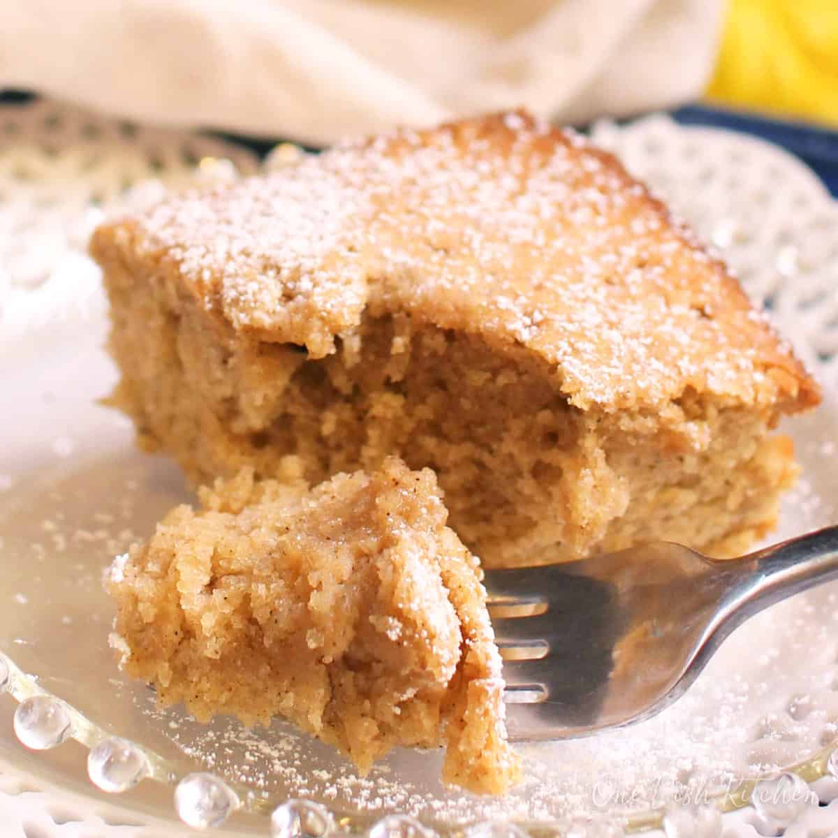 a slice of spice cake on a white plate.
