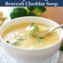 a white bowl filled with broccoli cheddar soup with a spoon on the side.