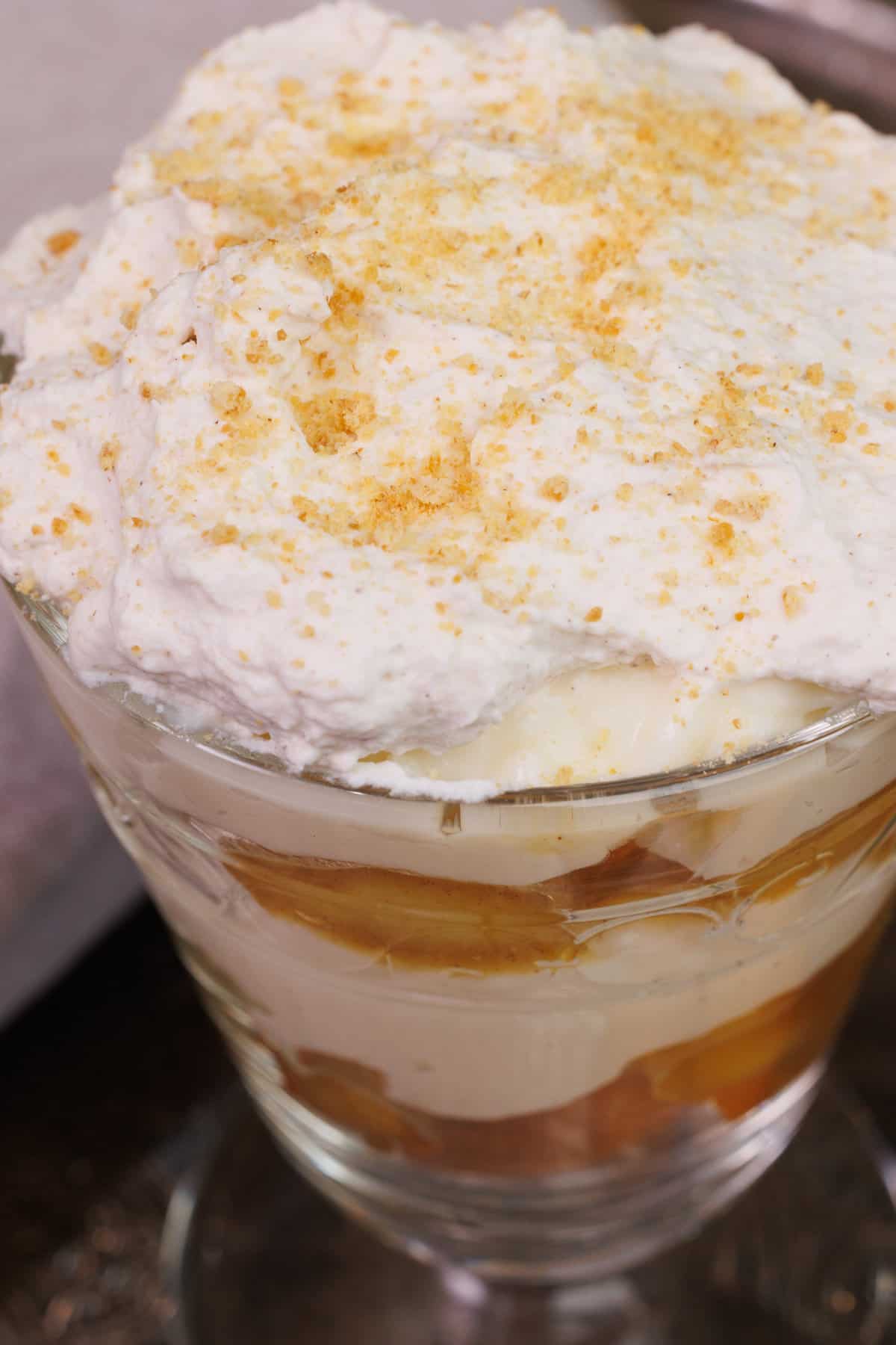 a layered banana trifle topped with whipped cream