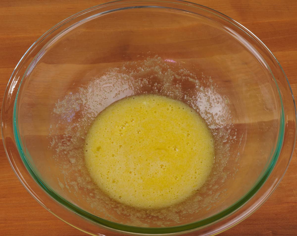 an egg and sugar in a mixing bowl