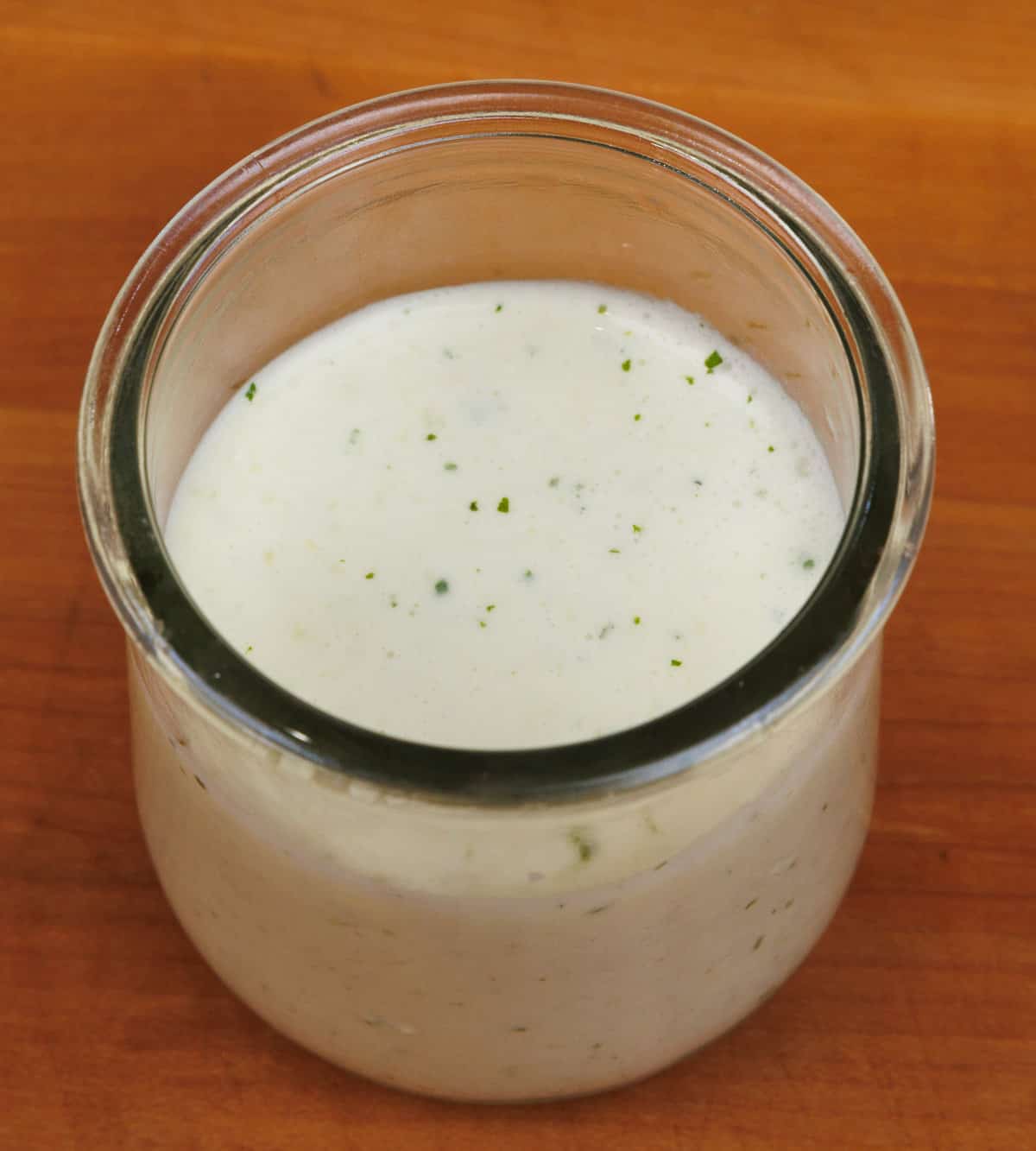 a small clear jar of tzatziki sauce