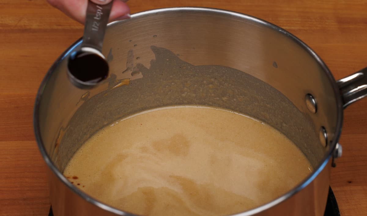 adding vanilla to fudge in a saucepan