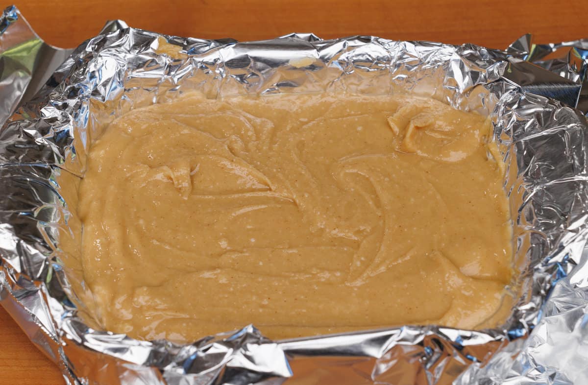 pouring fudge into a dish before refrigerating
