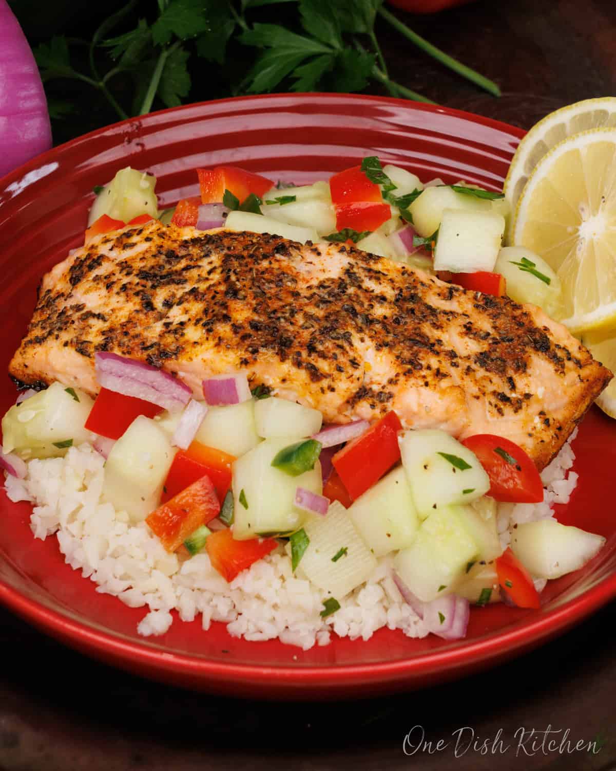 Salmon Bowl with a piece of salmon on vegetables and rice.