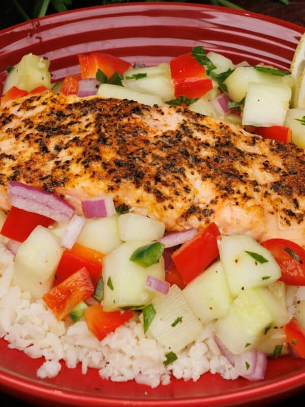 Salmon Bowl with a piece of salmon on vegetables and rice.