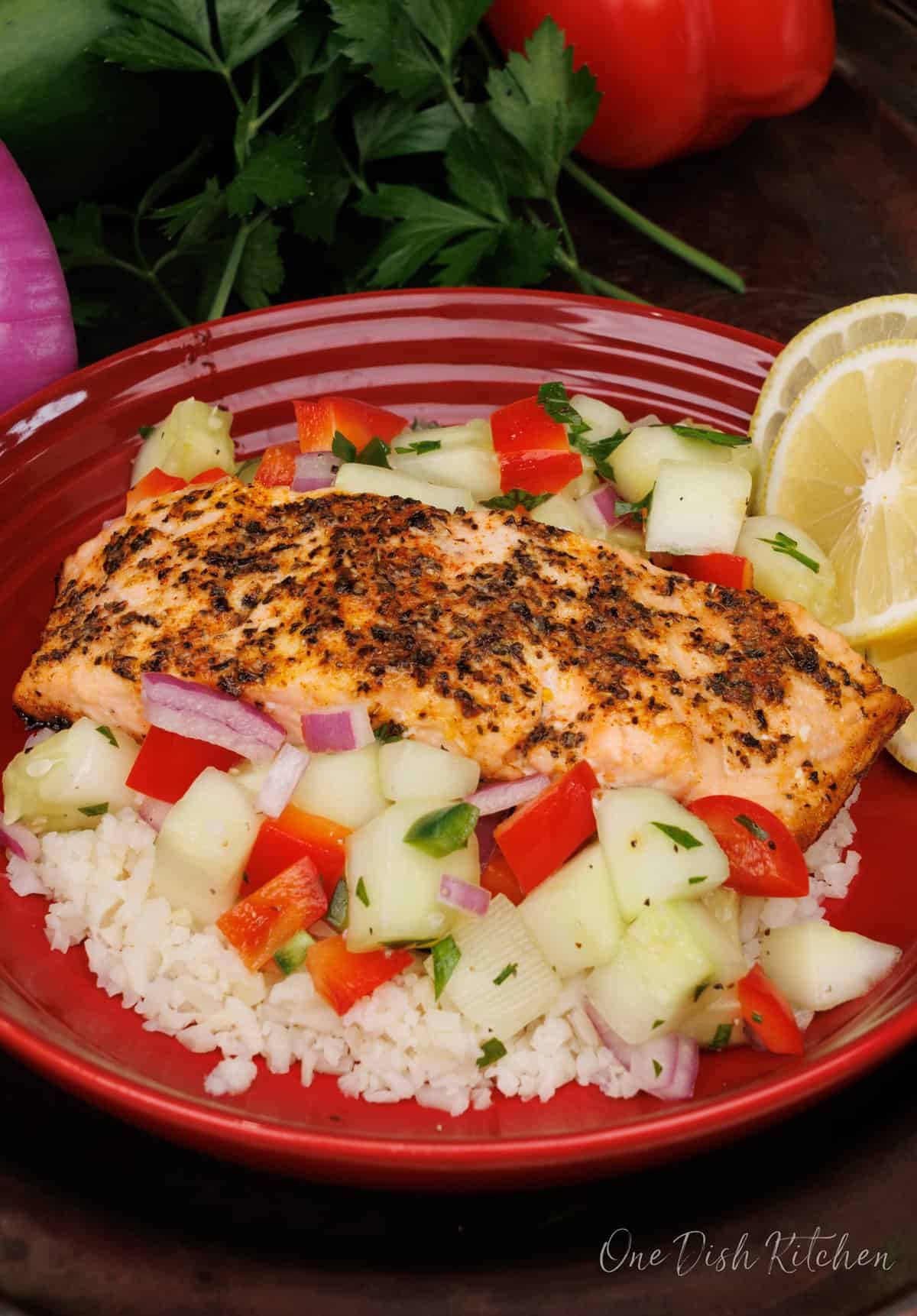 Salmon Bowl with a piece of salmon on vegetables and rice.