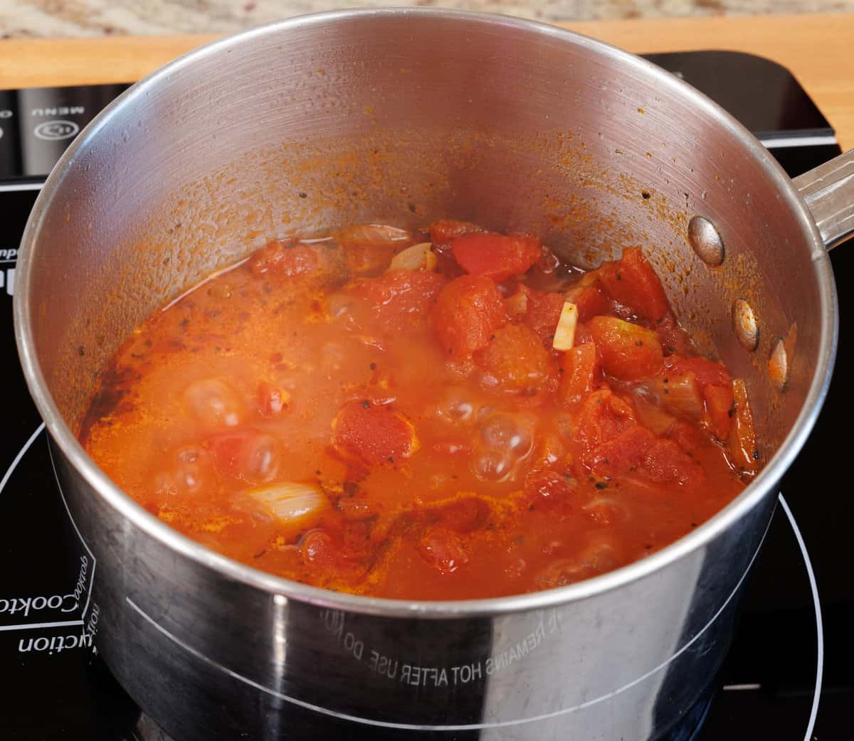 tomato soup simmering in a pot on the stove