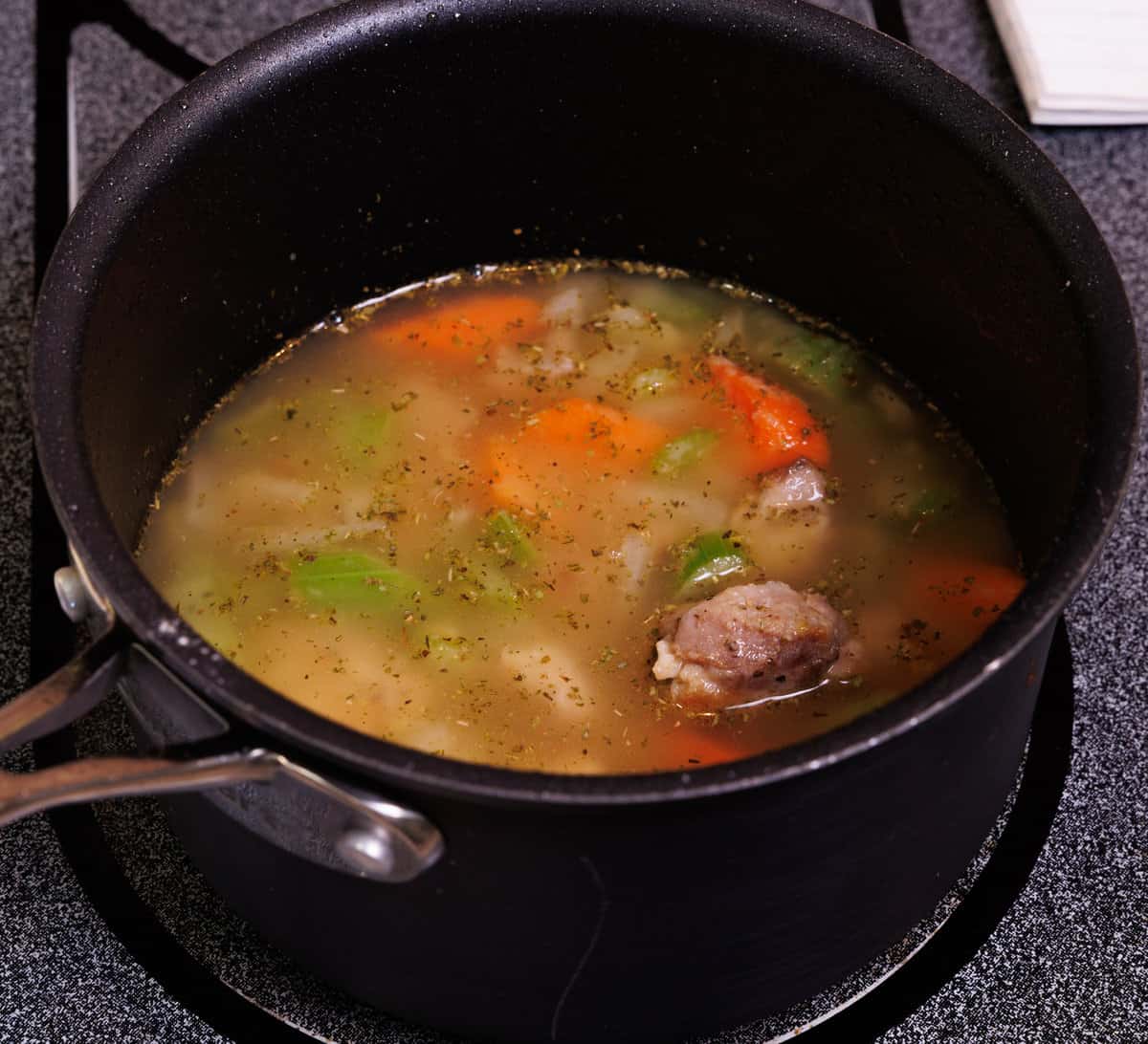 chicken soup simmering in a pot