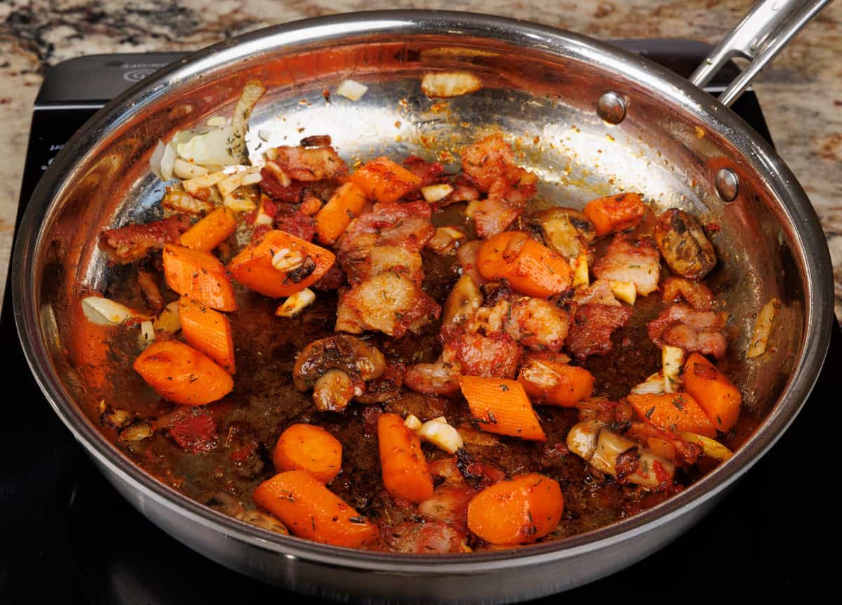 tomato paste, garlic, onions, carrots, and mushrooms sauteeing in a small skillet