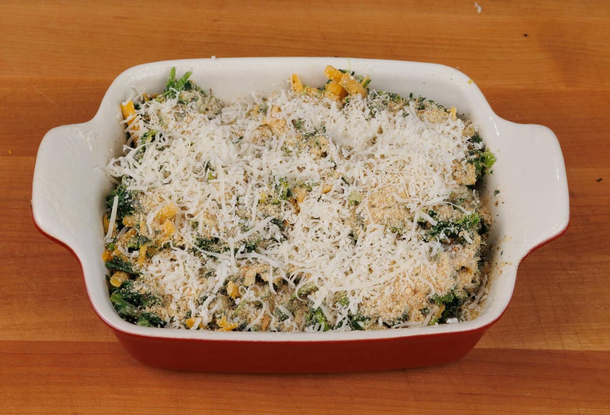 an unbaked spinach gratin in a baking dish 