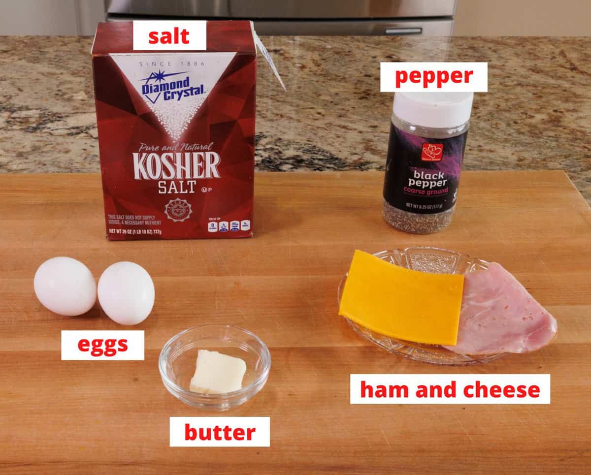 ingredients for a ham and cheese egg wrap on a kitchen counter