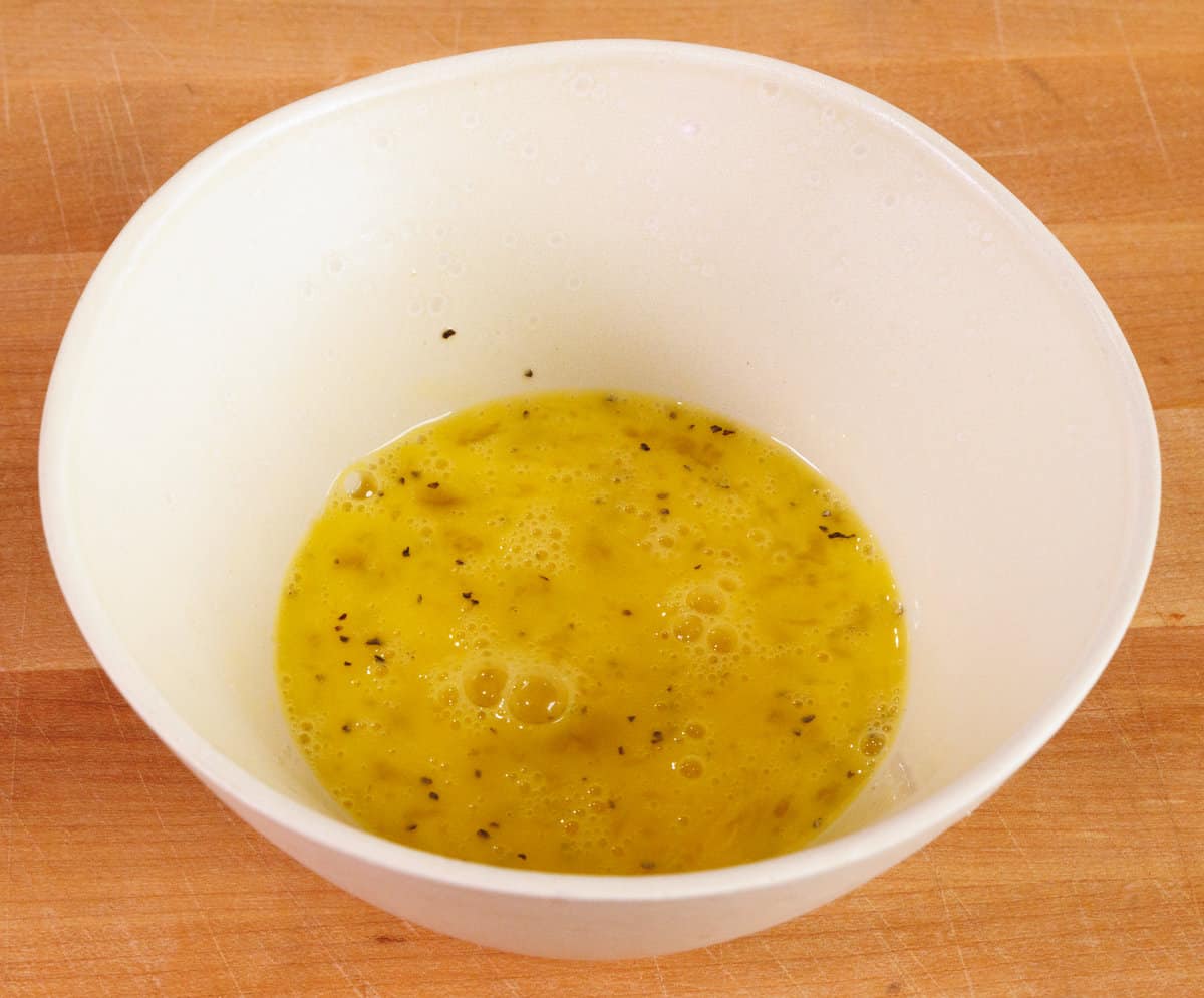 eggs, salt, and pepper in a white mixing bowl