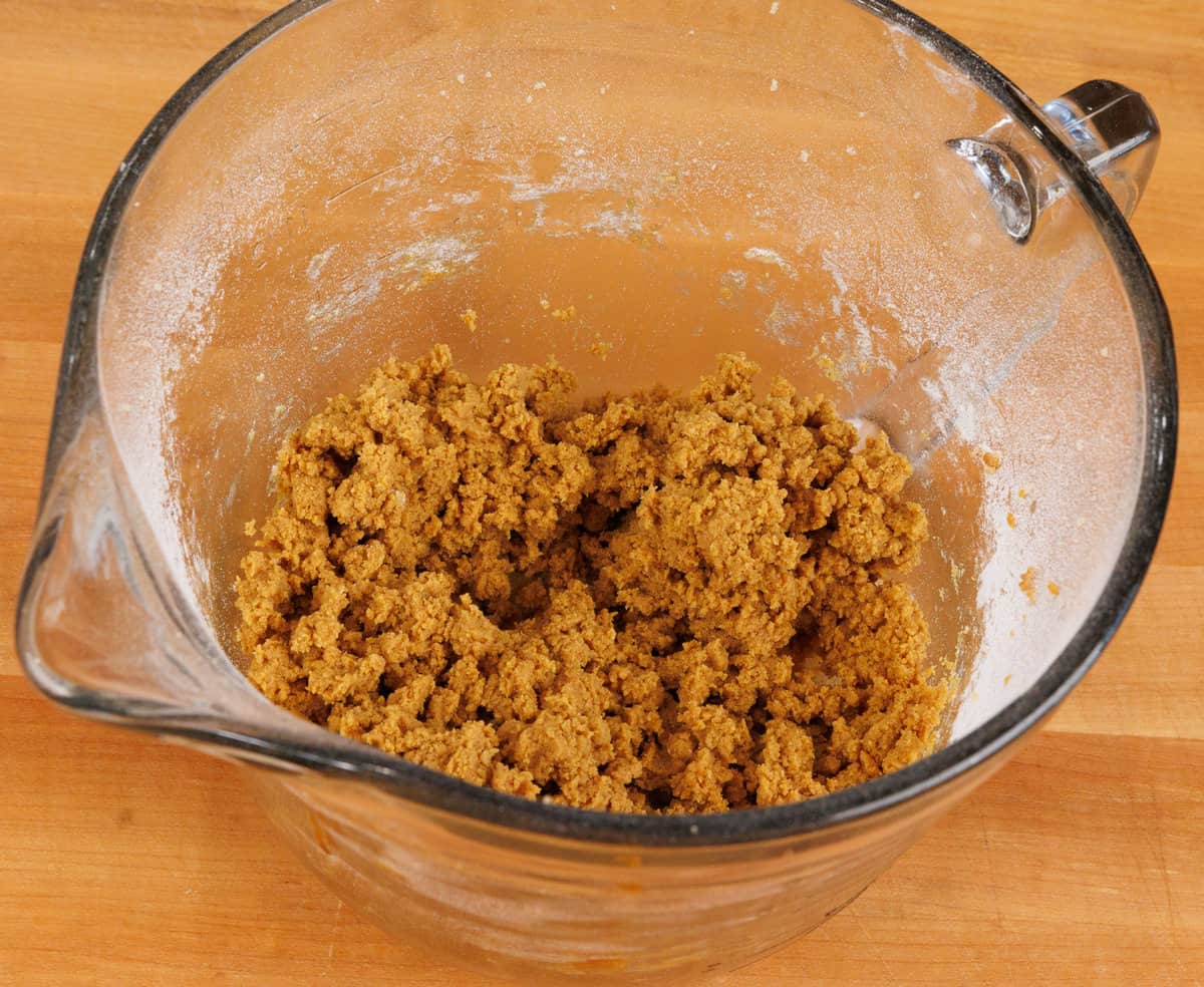 molasses cookie dough in a glass mixing bowl