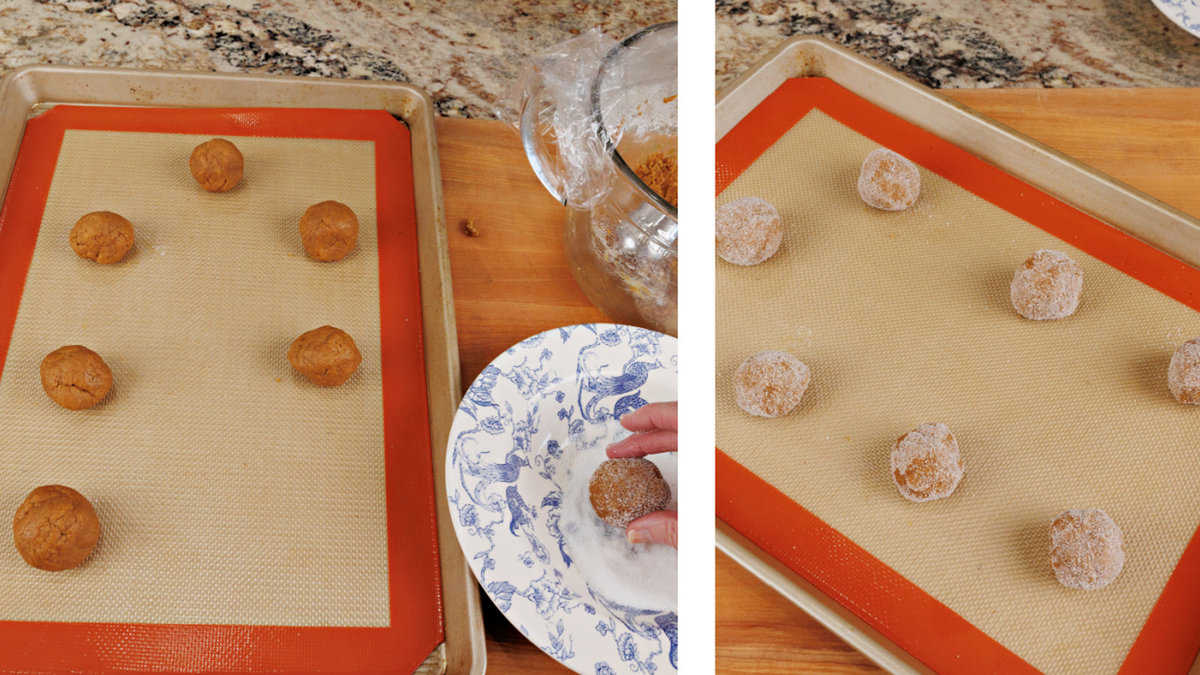 balls of molasses cookie dough rolled in granulated sugar and placed on a baking sheet