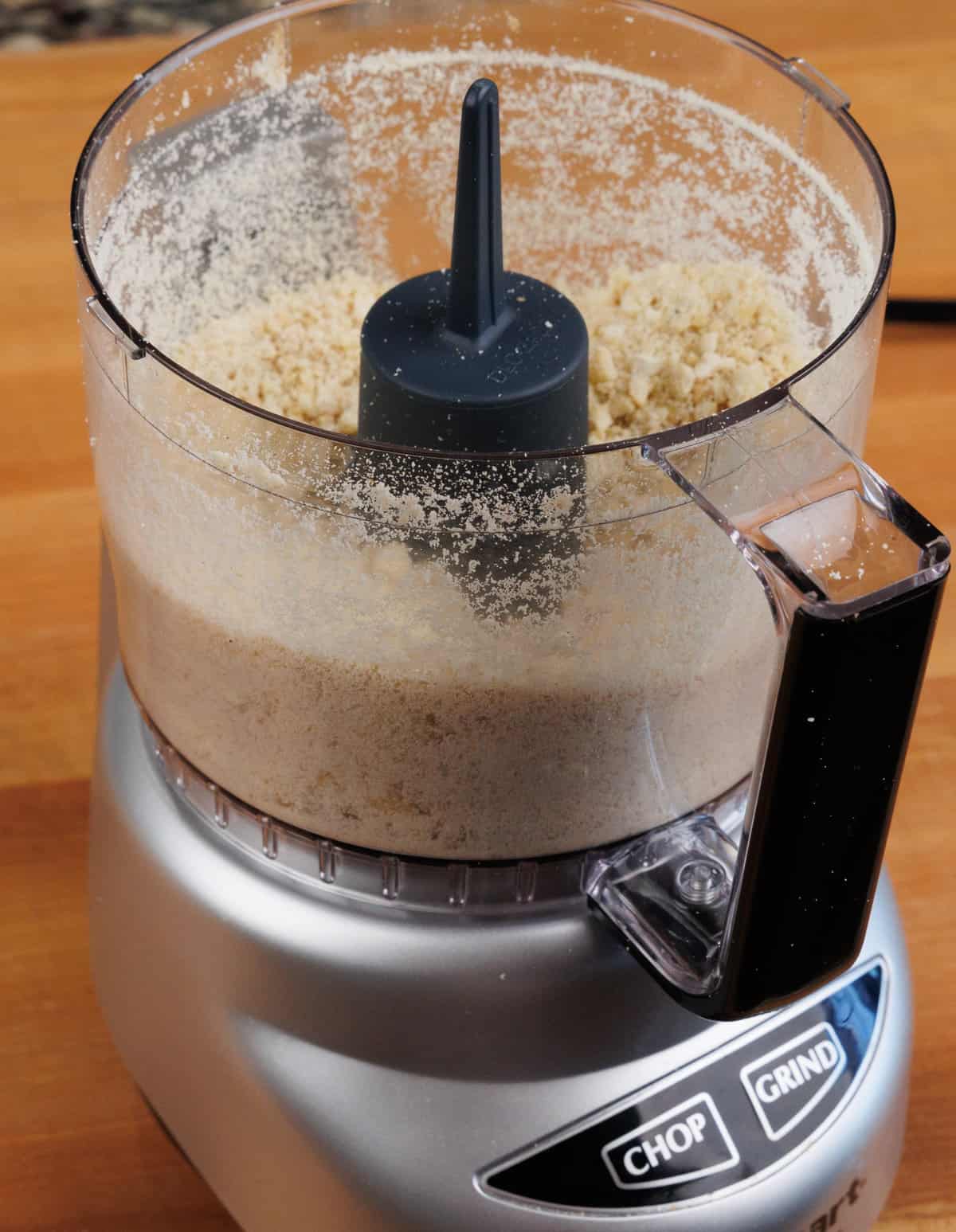 crushed nuts in the base of a food processor
