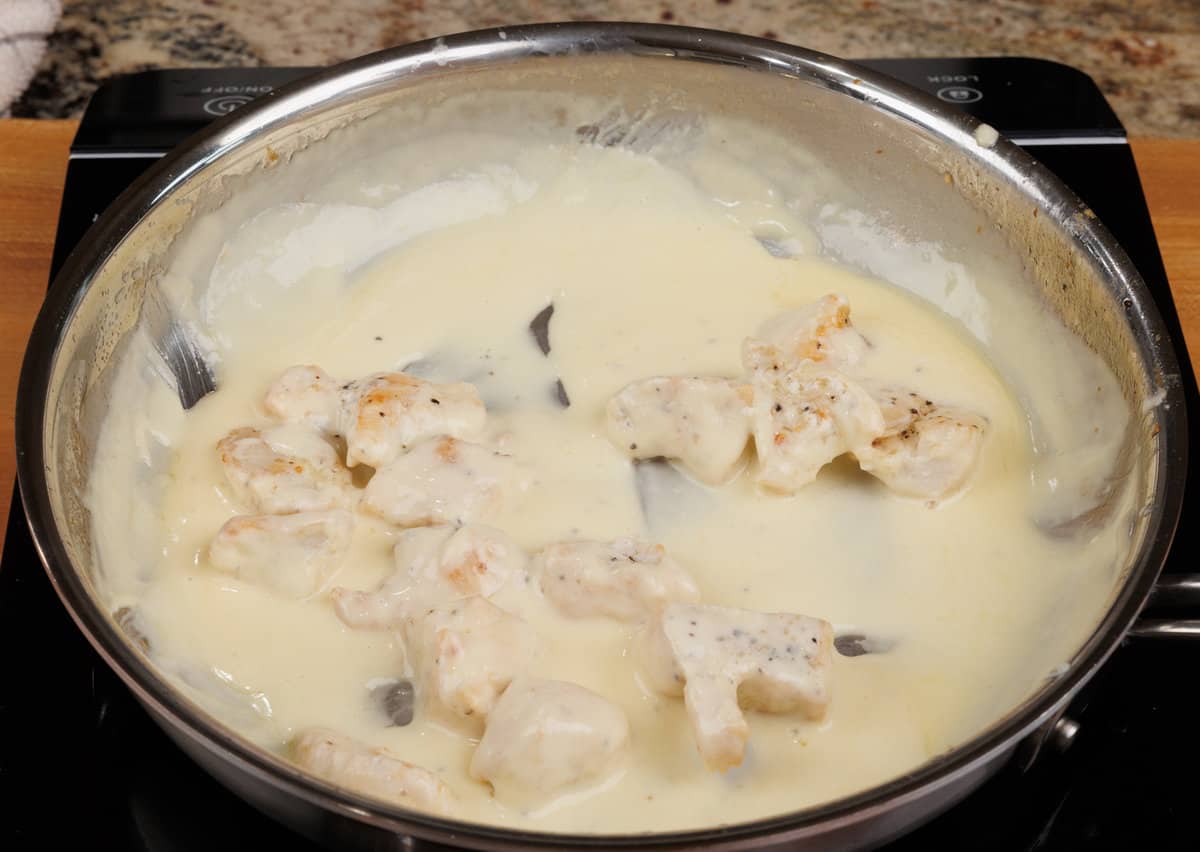 chicken in alfredo sauce in a pan