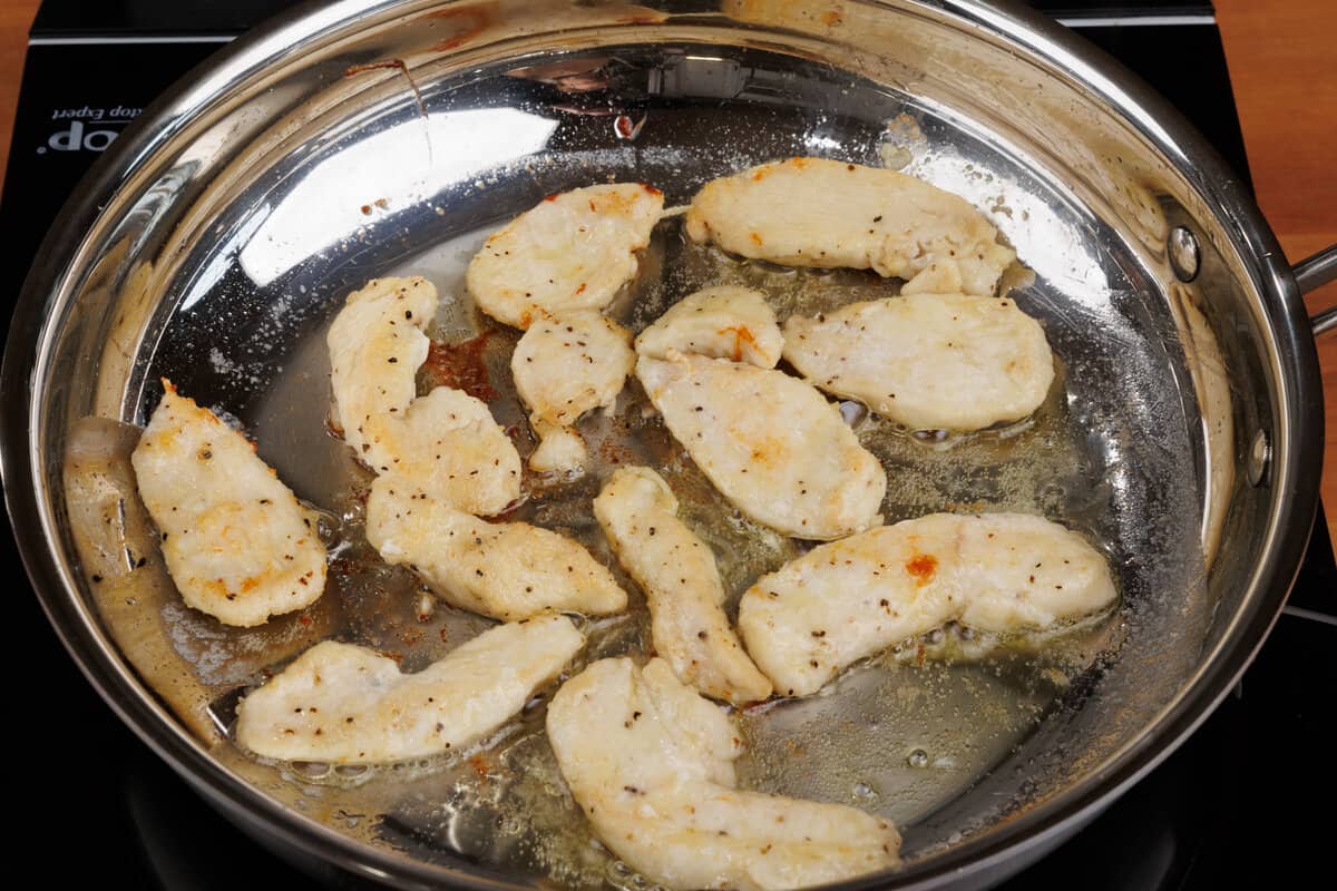 cooked chicken in butter in a skillet