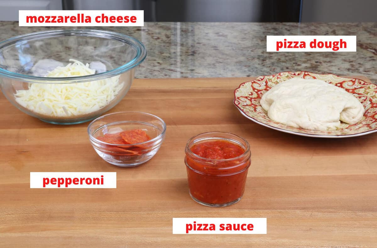 pepperoni pizza ingredients on a kitchen counter.