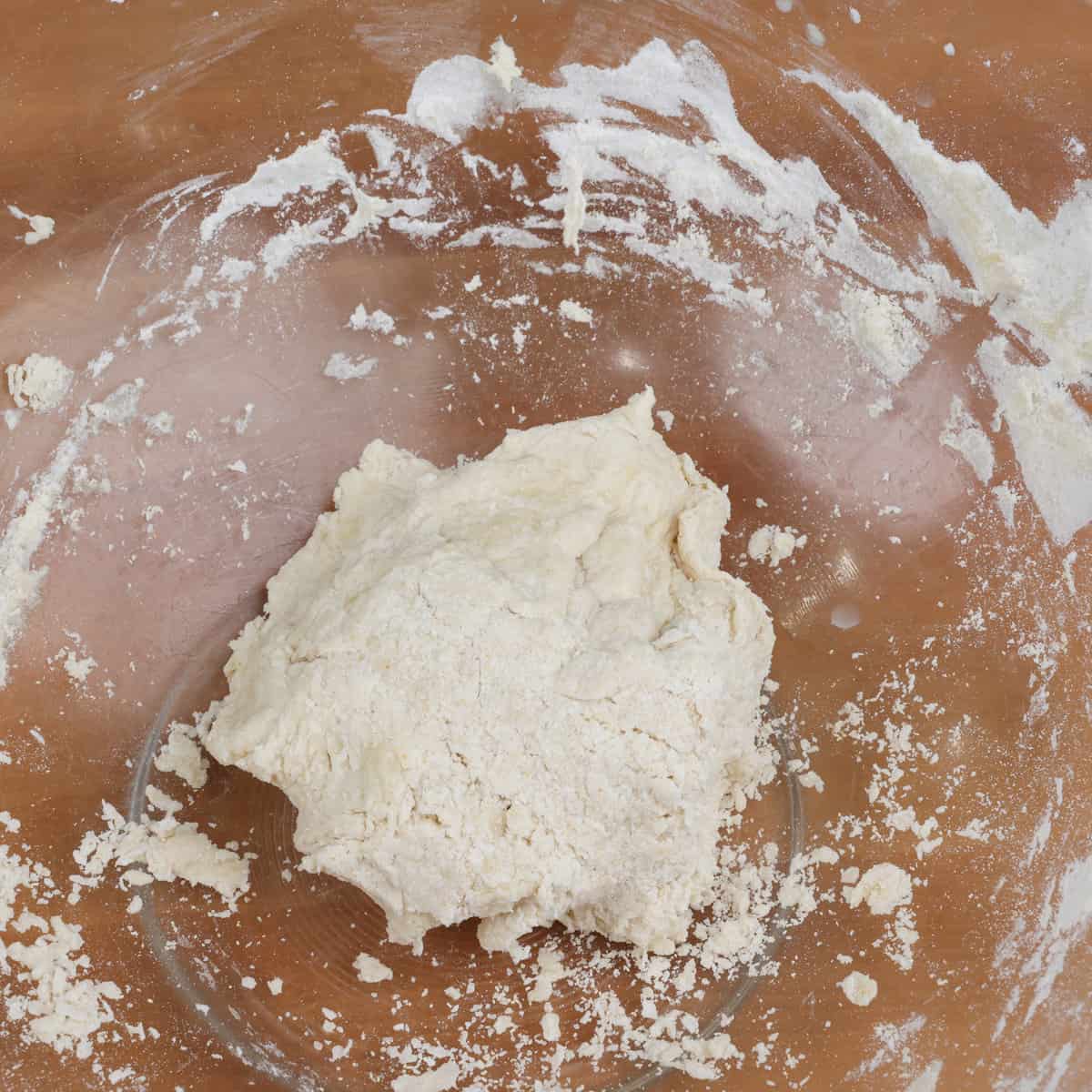 pizza dough in a mixing bowl before kneading.
