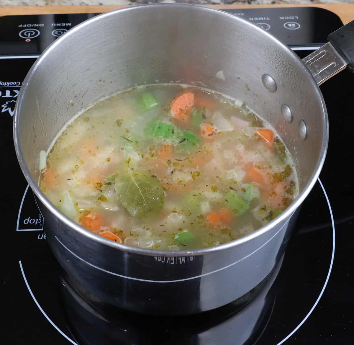 split pea soup simmering in a small pot on the stove.