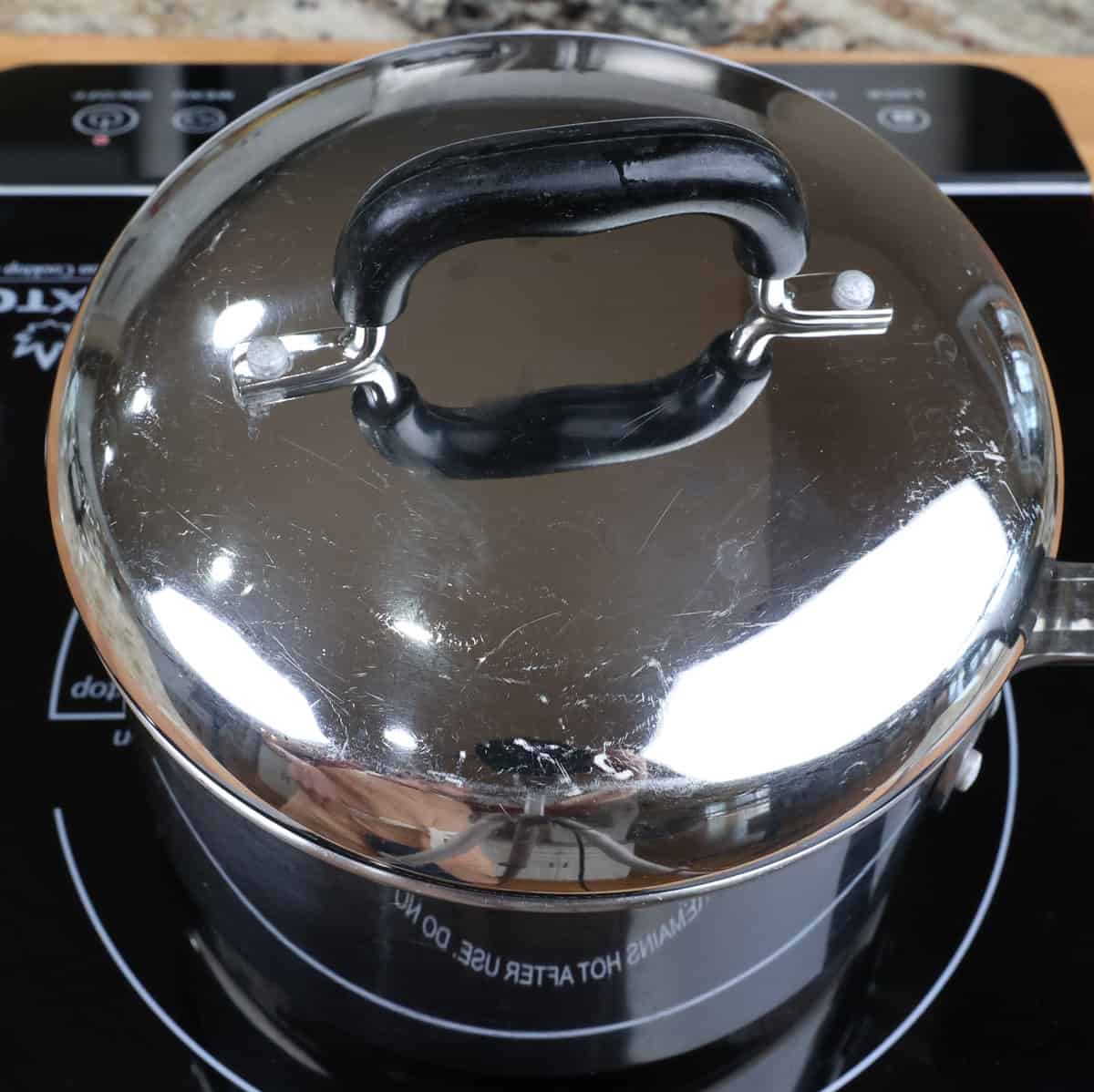 a covered pot on a stove.
