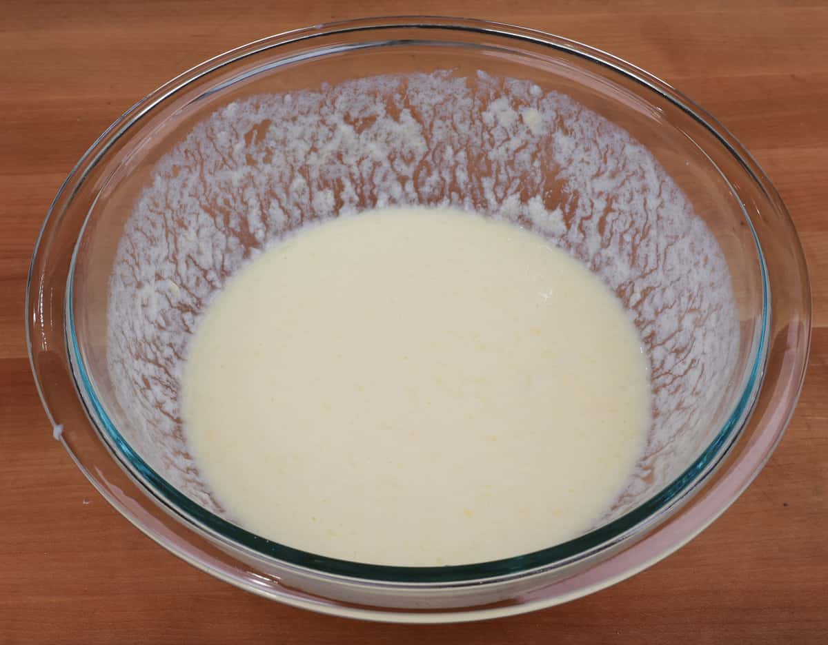buttermilk, egg, vanilla, and melted butter in a mixing bowl on a counter