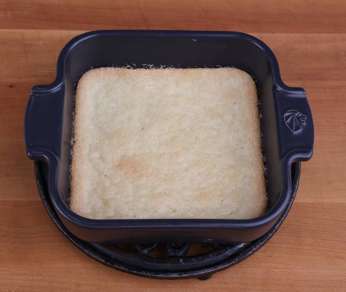 a small baked pie crust in a baking dish cooling on a kitchen counter