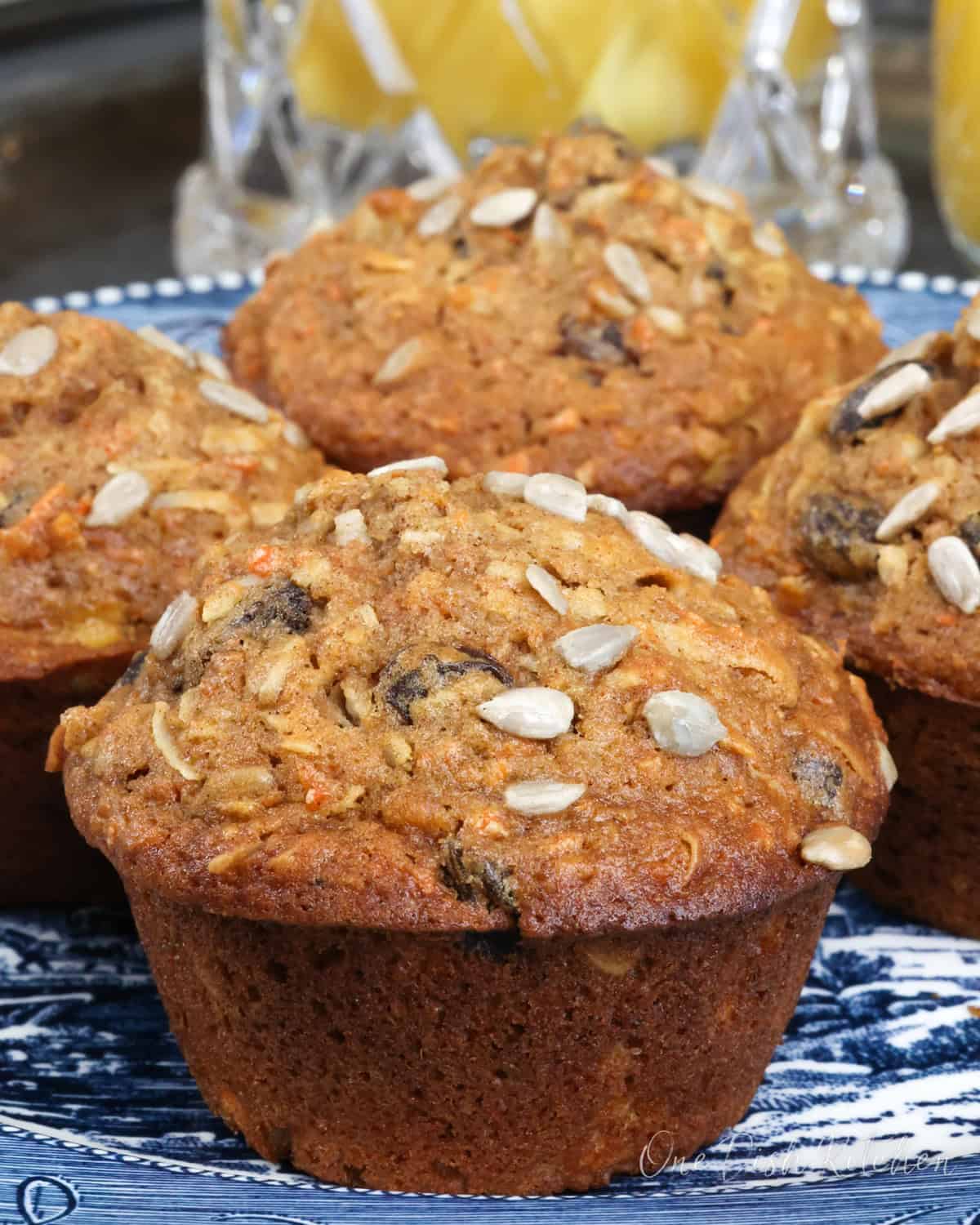 a small batch of morning glory muffins on a blue plate.