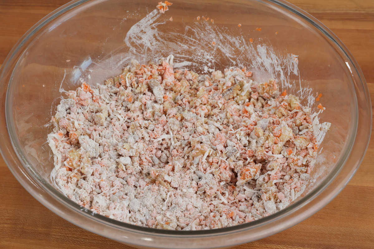 carrots, apples, and dry ingredients for muffins in a large mixing bowl.