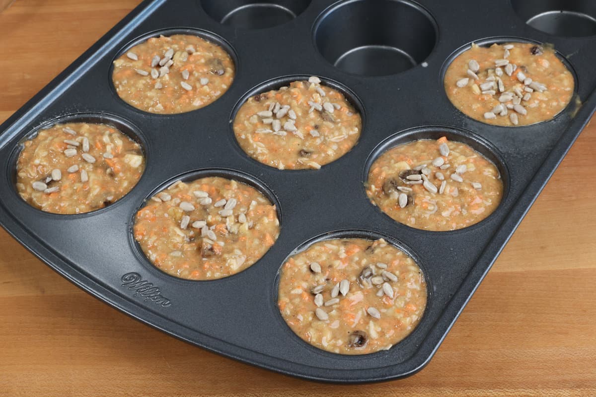 unbaked morning glory muffins in a muffin tin.