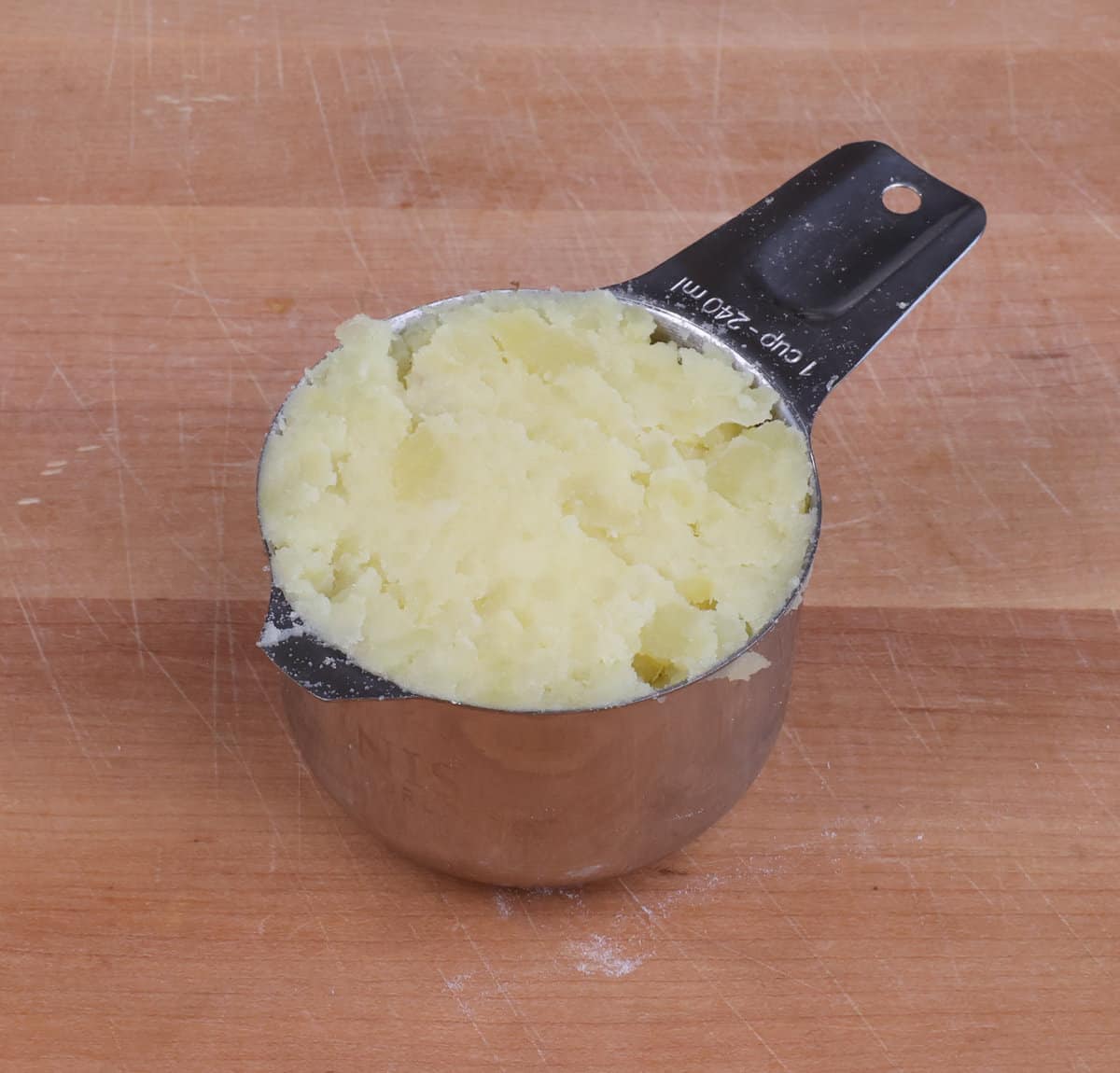 mashed potatoes packed into a measuring cup.