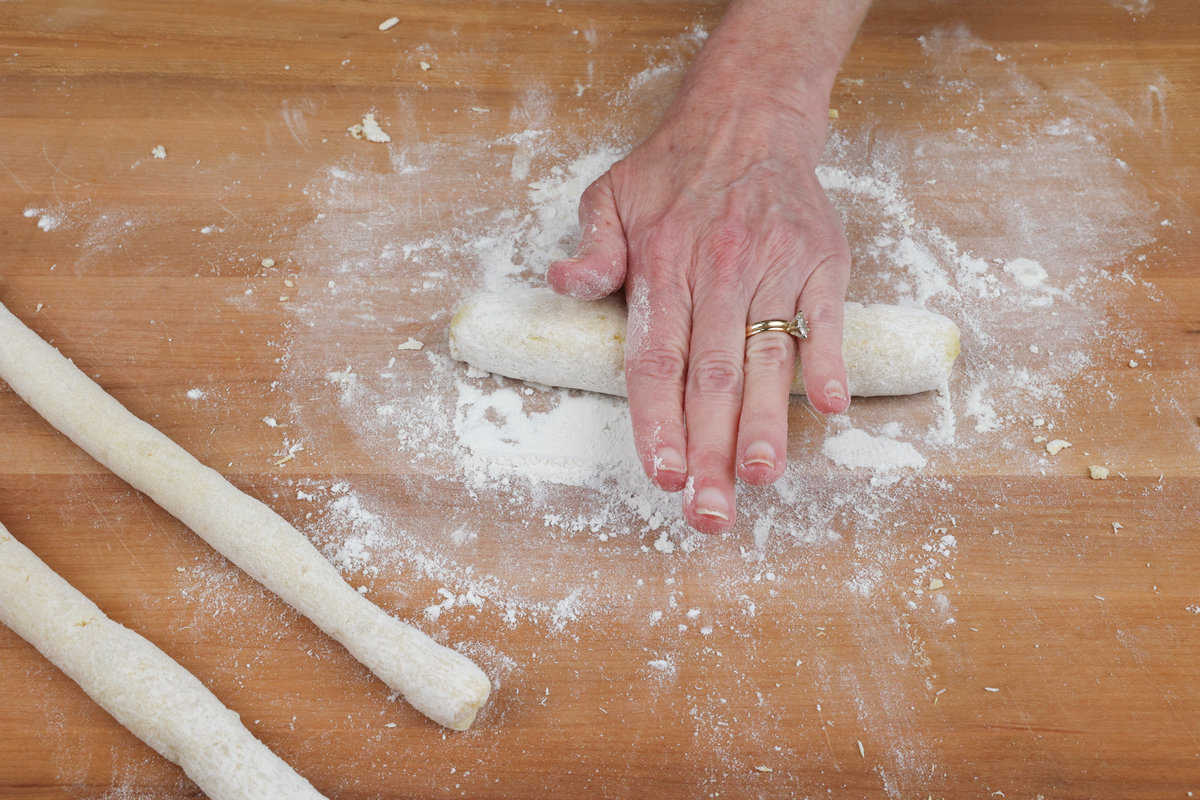 rolling potato gnocchi dough into long ropes.