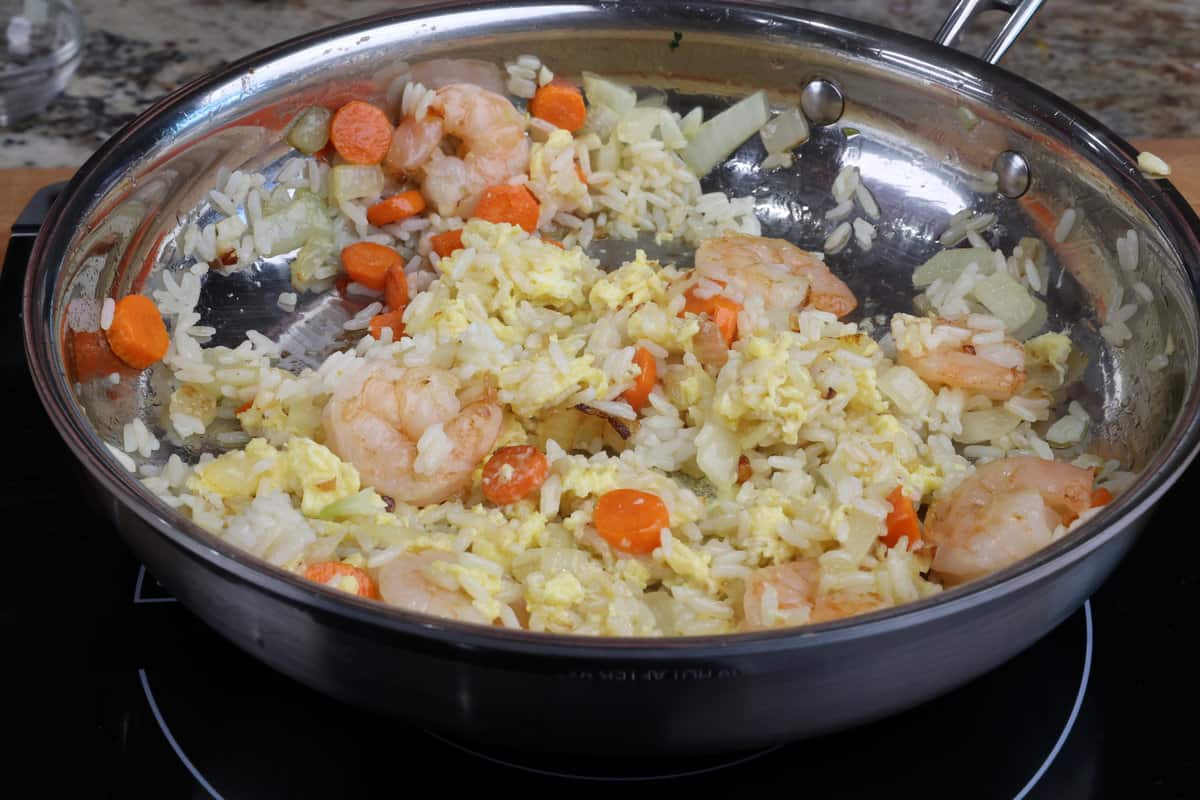 shrimp fried rice cooking in a skillet