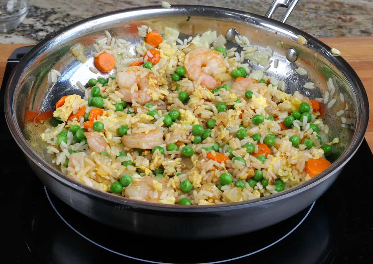 fried rice with shrimp and vegetables in a skillet