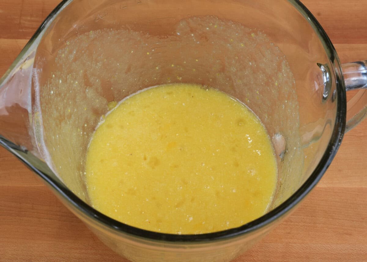 chess pie filling in a mixing bowl on a kitchen counter.