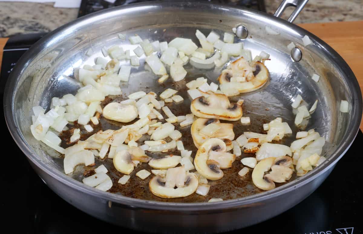 sliced mushrooms, onions and garlic in a skillet