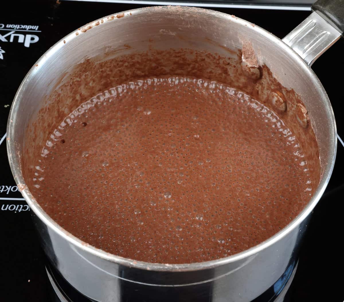 milk mixed with cocoa powder and sugar in a small saucepan