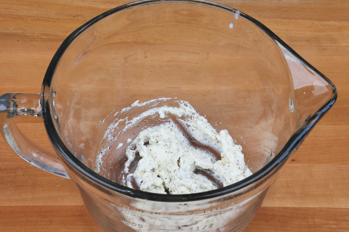 ricotta cheese and seasonings in a mixing bowl