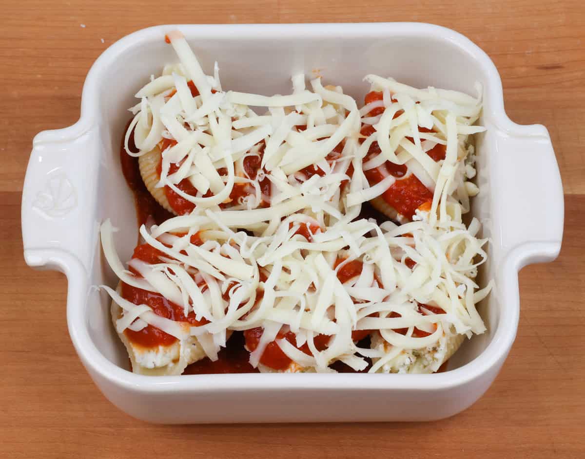 stuffed pasta shells topped with shredded mozzarella cheese