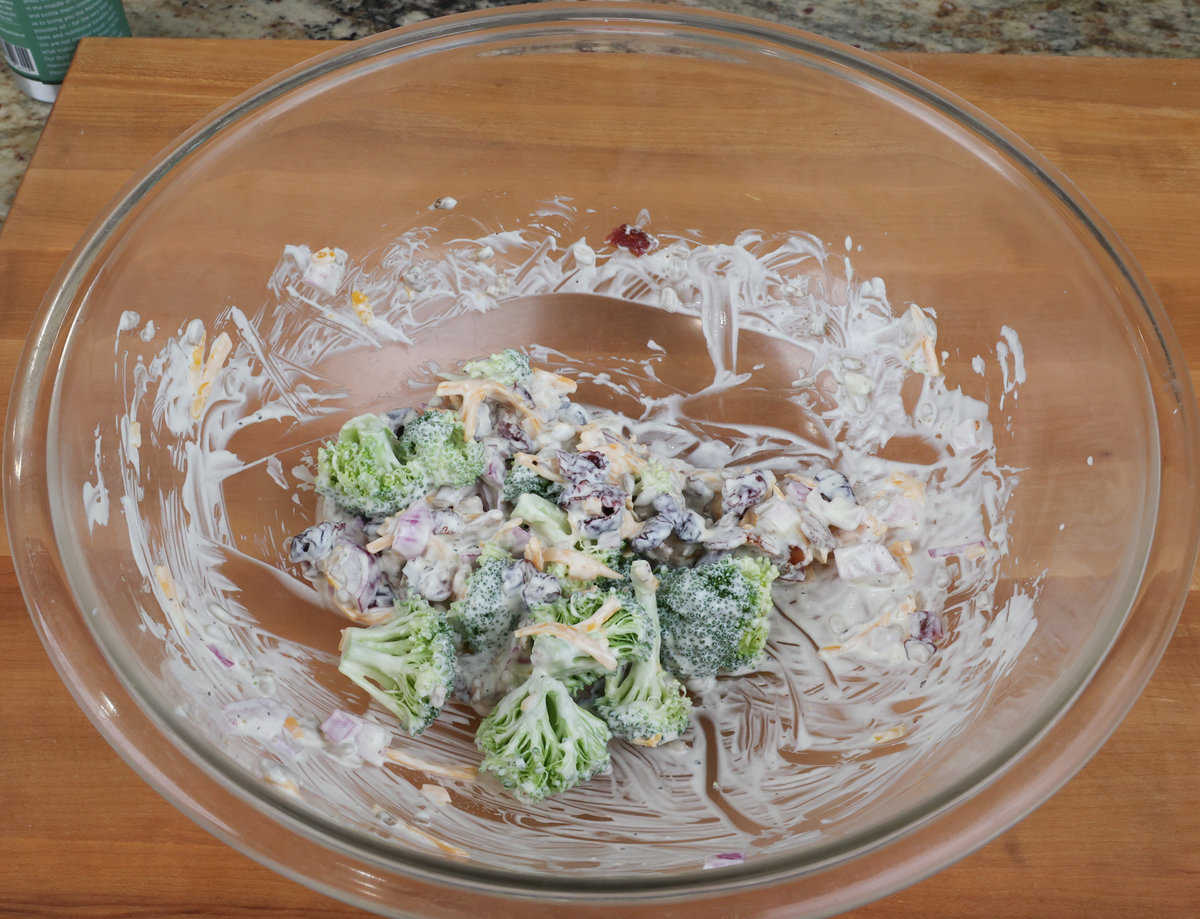 broccoli salad with dressing in a large mixing bowl.