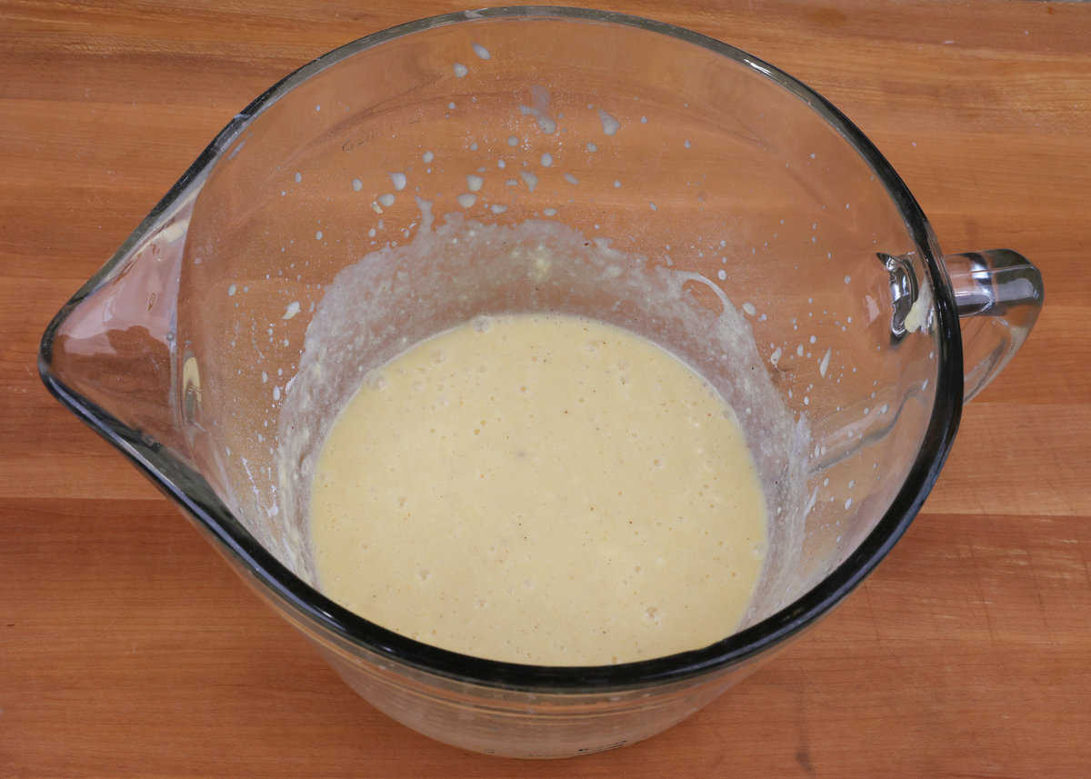 buttermilk pie filling in a large mixing bowl on a kitchen counter.