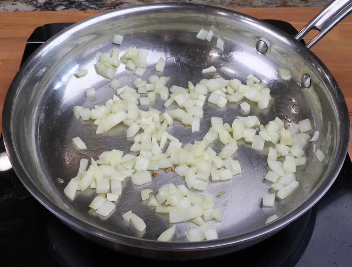 chopped onions cooking in a skillet
