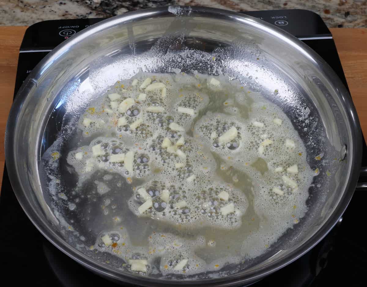 garlic, lemon zest, and butter in a small skillet on the stove.