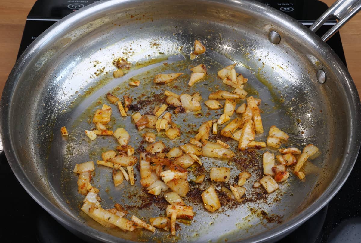 onions and garlic cooking in oil in a skillet.