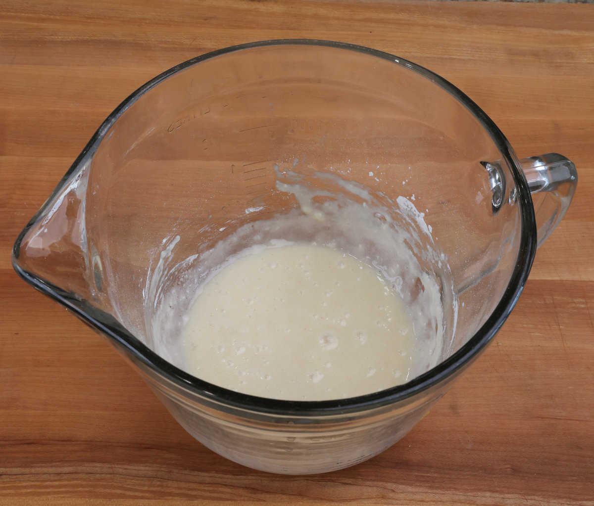 flour, an egg white, vanilla, and melted butter in a mixing bowl