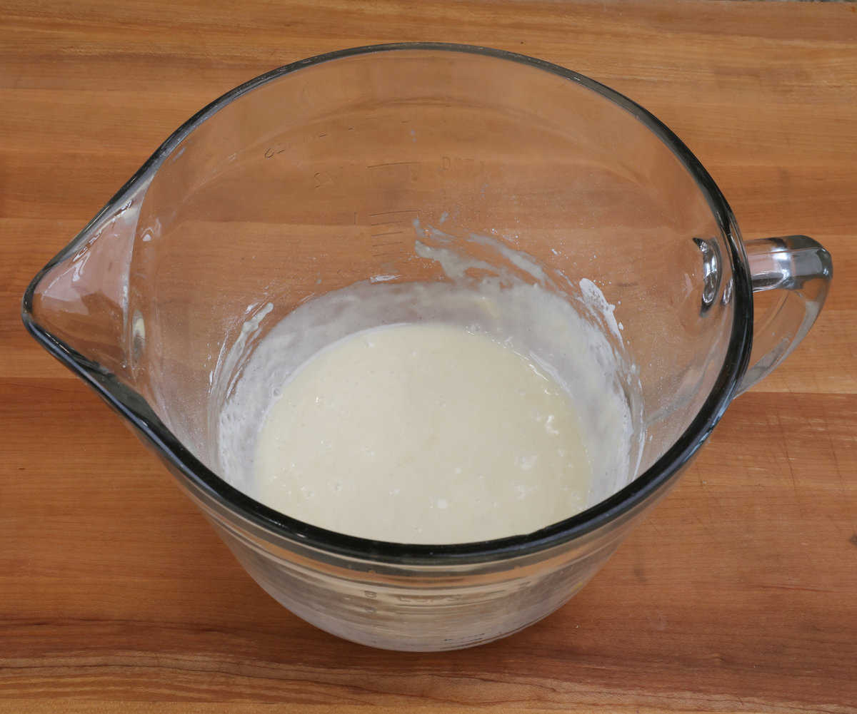 flour, an egg white, vanilla, and melted butter in a mixing bowl.
